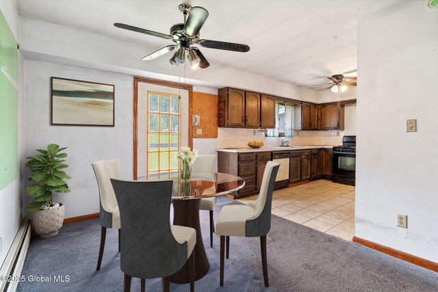 195 N St, Cobleskill, NY 12043 - dining space featuring a ceiling fan, a baseboard radiator, light colored carpet, and baseboards