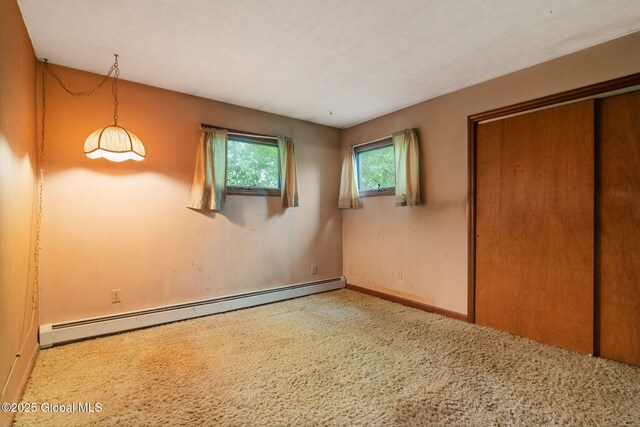 195 N St, Cobleskill, NY 12043 - unfurnished bedroom featuring a baseboard radiator, carpet floors, baseboards, and a closet