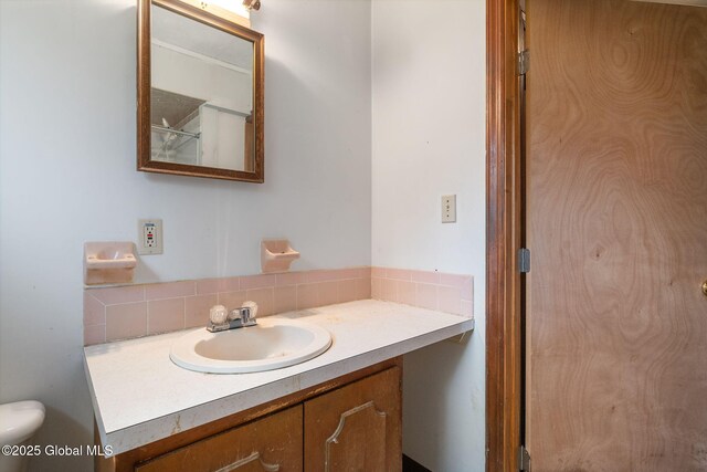195 N St, Cobleskill, NY 12043 - bathroom featuring vanity, decorative backsplash, and toilet