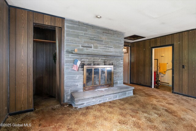 195 N St, Cobleskill, NY 12043 - unfurnished living room featuring wood walls, carpet flooring, and a fireplace