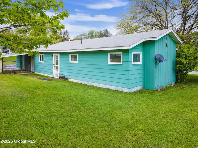 195 N St, Cobleskill, NY 12043 - rear view of house with a lawn and roof with shingles