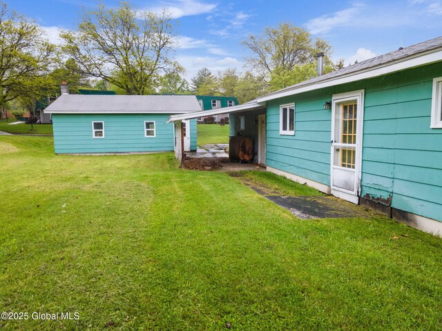 195 N St, Cobleskill, NY 12043 - rear view of house featuring a lawn