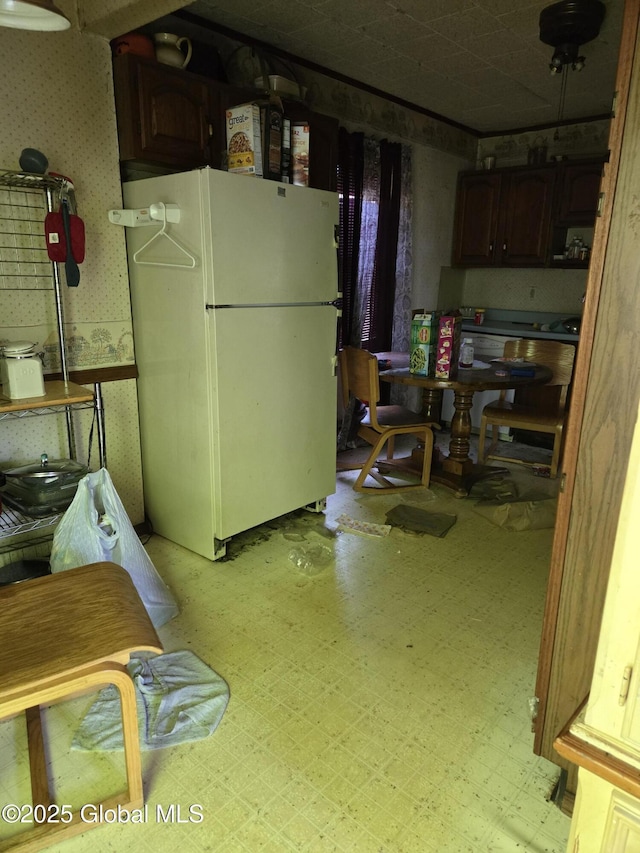 14 Western Ave, Colonie, NY 12189 - below grade area featuring freestanding refrigerator, wallpapered walls, light floors, and a wainscoted wall