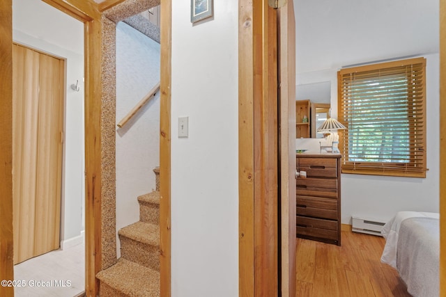 858 E River Dr, Lake Luzerne, NY 12846 - staircase featuring a baseboard radiator and wood finished floors