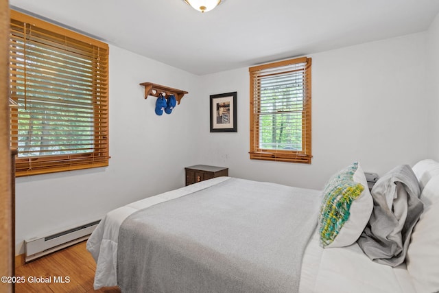 858 E River Dr, Lake Luzerne, NY 12846 - bedroom with a baseboard radiator and wood finished floors