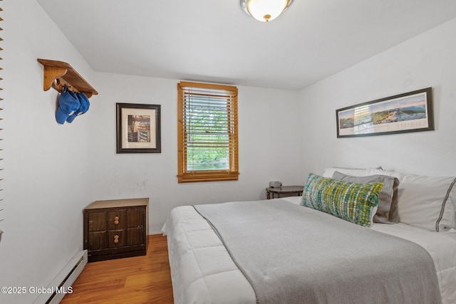 858 E River Dr, Lake Luzerne, NY 12846 - bedroom featuring light wood-type flooring and baseboard heating