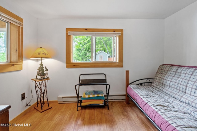 858 E River Dr, Lake Luzerne, NY 12846 - bedroom featuring wood finished floors, a baseboard heating unit, and baseboards
