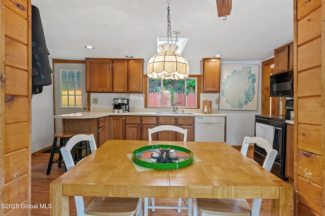 858 E River Dr, Lake Luzerne, NY 12846 - kitchen featuring black appliances, a sink, healthy amount of natural light, brown cabinets, and recessed lighting