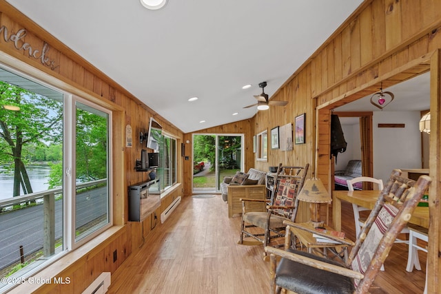 858 E River Dr, Lake Luzerne, NY 12846 - sunroom / solarium featuring plenty of natural light, wooden walls, baseboard heating, a ceiling fan, and wood finished floors
