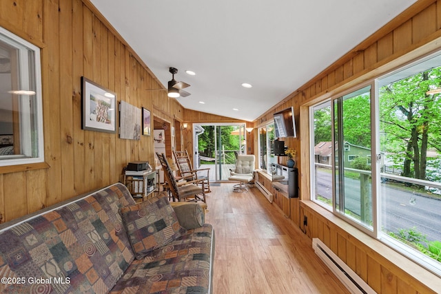 858 E River Dr, Lake Luzerne, NY 12846 - living area featuring lofted ceiling, wooden walls, healthy amount of natural light, light wood finished floors, and a ceiling fan