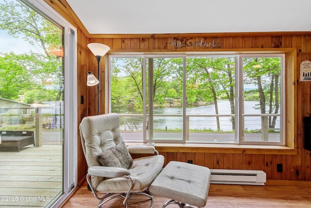 858 E River Dr, Lake Luzerne, NY 12846 - living area with a baseboard radiator, wooden walls, a water view, and healthy amount of natural light