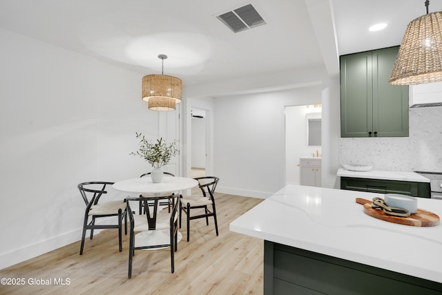 106 E Berkley Sq, Glenville, NY 12302 - kitchen with green cabinetry, light wood-type flooring, pendant lighting, light stone countertops, and recessed lighting