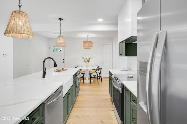 106 E Berkley Sq, Glenville, NY 12302 - kitchen with appliances with stainless steel finishes, green cabinets, light wood-style flooring, recessed lighting, and light stone countertops
