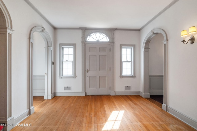 2125 Rosendale Rd, Niskayuna, NY 12309 - entryway featuring crown molding, light wood-style flooring, plenty of natural light, baseboards, and arched walkways