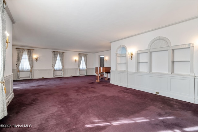 2125 Rosendale Rd, Niskayuna, NY 12309 - unfurnished living room featuring carpet, a decorative wall, and wainscoting