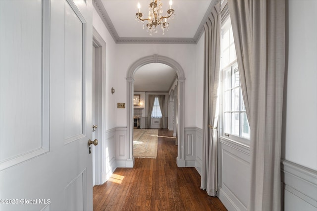 2125 Rosendale Rd, Niskayuna, NY 12309 - hall with arched walkways, healthy amount of natural light, a chandelier, dark wood-style floors, and a decorative wall