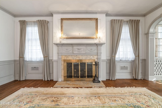 2125 Rosendale Rd, Niskayuna, NY 12309 - living area featuring wood finished floors, healthy amount of natural light, a wainscoted wall, a high end fireplace, and a decorative wall