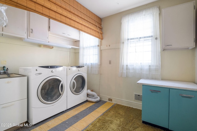 2125 Rosendale Rd, Niskayuna, NY 12309 - washroom with cabinet space, washer and dryer, and light tile patterned flooring