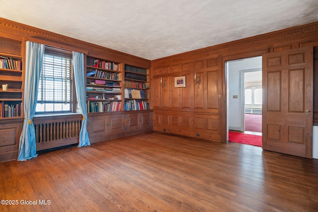 2125 Rosendale Rd, Niskayuna, NY 12309 - spare room featuring wood finished floors, wooden walls, and ornamental molding
