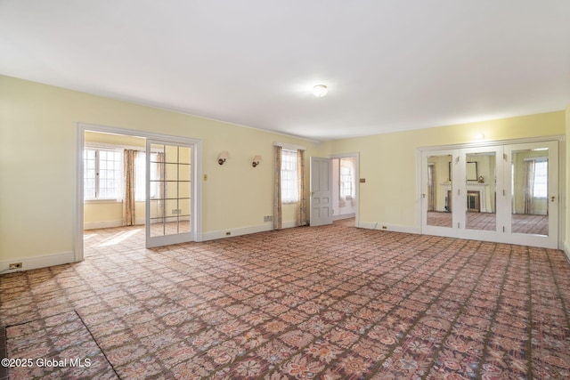 2125 Rosendale Rd, Niskayuna, NY 12309 - unfurnished living room featuring carpet floors, plenty of natural light, and baseboards