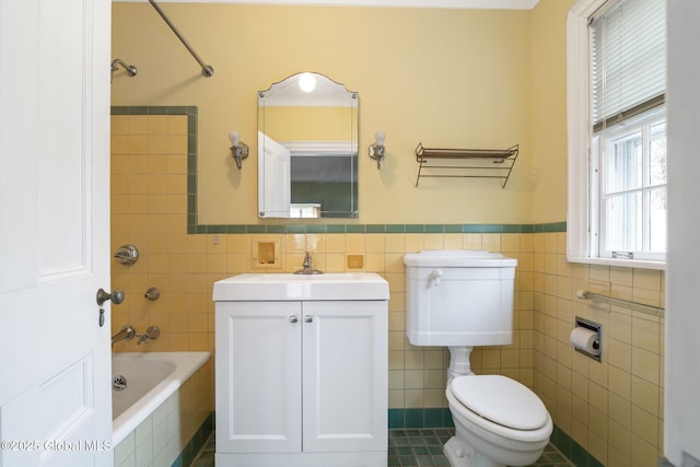 2125 Rosendale Rd, Niskayuna, NY 12309 - bathroom featuring toilet, tile walls, tiled shower / bath, vanity, and a wainscoted wall