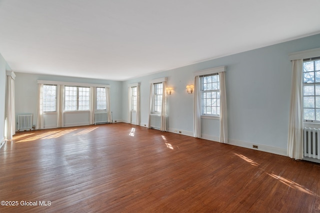 2125 Rosendale Rd, Niskayuna, NY 12309 - unfurnished living room with radiator heating unit, wood finished floors, and baseboards