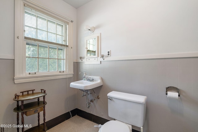 2125 Rosendale Rd, Niskayuna, NY 12309 - half bathroom with toilet, tile walls, a sink, and wainscoting