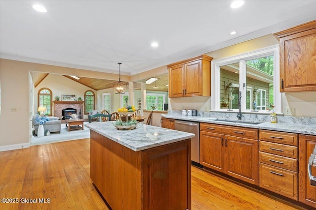 19 Canterbury Rd, Clifton Park, NY 12065 - kitchen featuring dishwasher, a center island, light stone counters, light wood-type flooring, and a fireplace