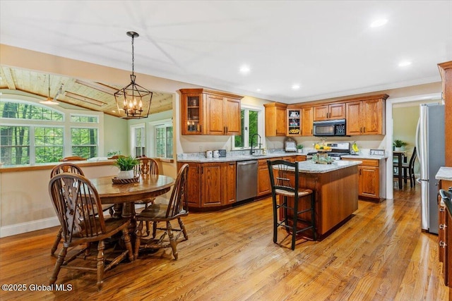 19 Canterbury Rd, Clifton Park, NY 12065 - kitchen with stainless steel appliances, brown cabinets, a kitchen island, light countertops, and recessed lighting