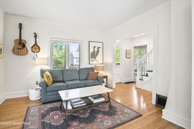 30 Monument Ave, Glens Falls, NY 12801 - living area with wood finished floors, stairs, baseboards, and ornamental molding