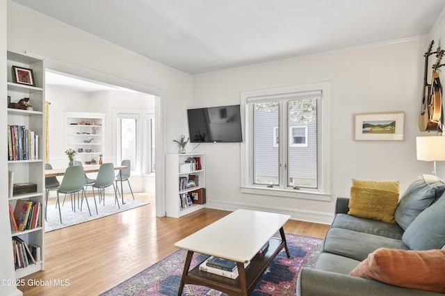 30 Monument Ave, Glens Falls, NY 12801 - living room with wood finished floors, ornamental molding, and baseboards
