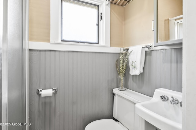 30 Monument Ave, Glens Falls, NY 12801 - bathroom featuring a sink, toilet, and wainscoting