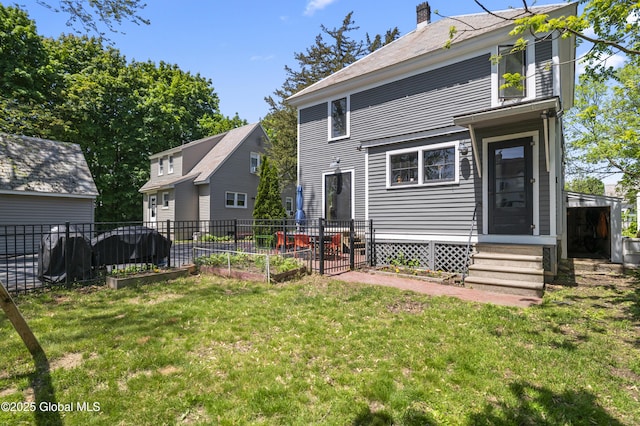30 Monument Ave, Glens Falls, NY 12801 - back of property featuring entry steps, a chimney, and a vegetable garden