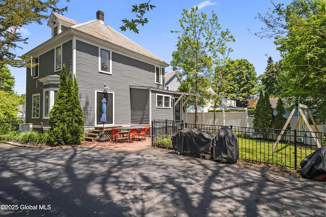30 Monument Ave, Glens Falls, NY 12801 - rear view of property with a patio area, a chimney, central AC, and a shingled roof