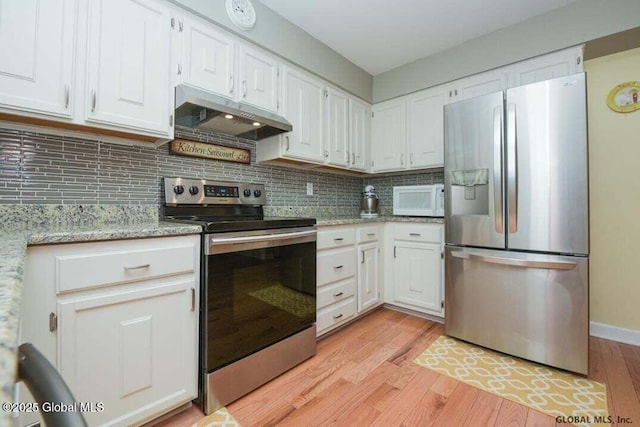 198 Williamsburg Ct, Albany, NY 12203 - kitchen featuring appliances with stainless steel finishes, under cabinet range hood, light wood-style flooring, white cabinetry, and tasteful backsplash
