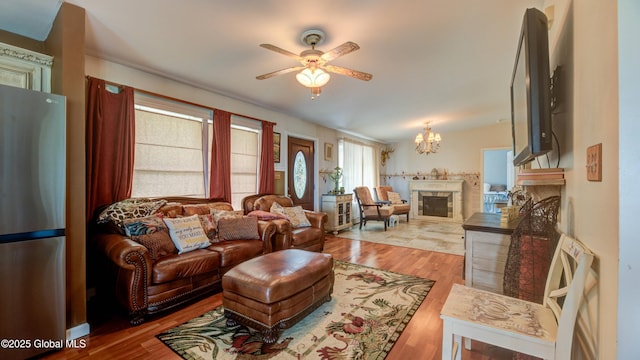 127 Firefly Meadow Rd, Glen, NY 12072 - living area featuring a ceiling fan, a chandelier, wood finished floors, and a fireplace