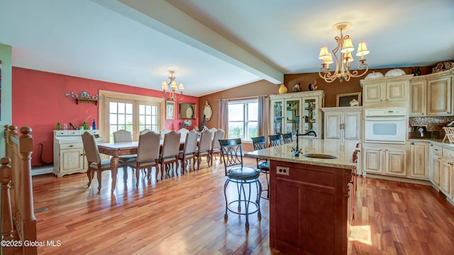 127 Firefly Meadow Rd, Glen, NY 12072 - kitchen featuring a chandelier, oven, cream cabinets, a sink, and light wood-style flooring