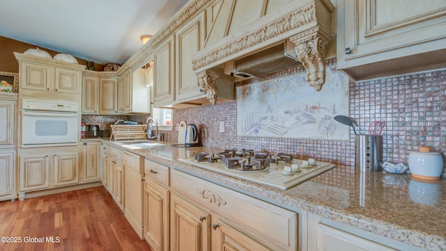 127 Firefly Meadow Rd, Glen, NY 12072 - kitchen featuring white appliances, under cabinet range hood, a sink, tasteful backsplash, and cream cabinetry