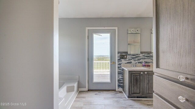 127 Firefly Meadow Rd, Glen, NY 12072 - full bath with vanity, a garden tub, backsplash, wood finished floors, and baseboards