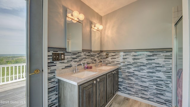 127 Firefly Meadow Rd, Glen, NY 12072 - full bathroom with wood finished floors, double vanity, tasteful backsplash, and a chandelier