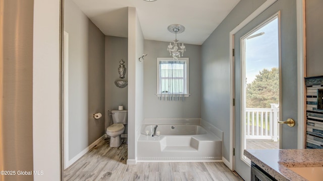 127 Firefly Meadow Rd, Glen, NY 12072 - full bathroom featuring a garden tub, toilet, wood finished floors, and a chandelier