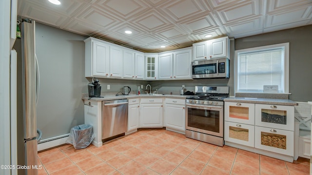 127 Firefly Meadow Rd, Glen, NY 12072 - kitchen featuring stainless steel appliances, a sink, a baseboard heating unit, recessed lighting, and an ornate ceiling