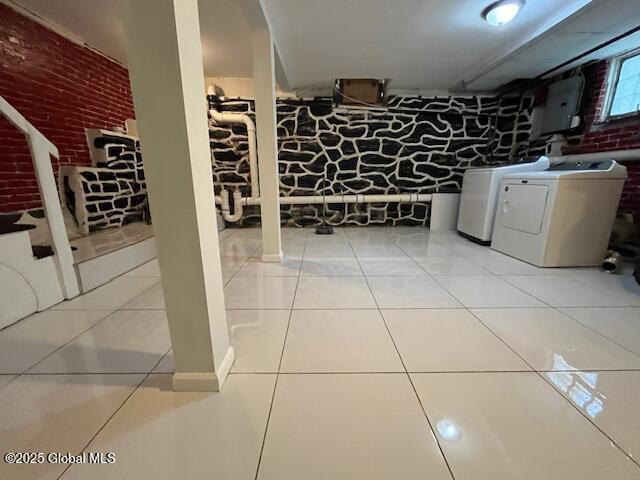 201 10th St, Troy, NY 12180 - laundry room featuring washer and dryer, electric panel, brick wall, and tile patterned flooring