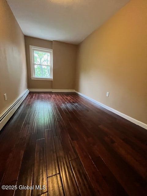 201 10th St, Troy, NY 12180 - empty room featuring hardwood / wood-style floors, baseboards, and a baseboard radiator