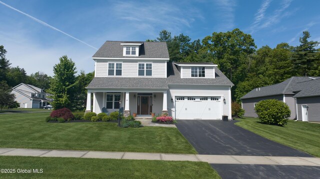 26 Galleon Dr Unit 26, Malta, NY 12020 - view of front facade with a porch, driveway, a front lawn, and roof with shingles