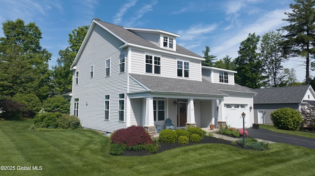 26 Galleon Dr Unit 26, Malta, NY 12020 - view of front of house featuring a porch, a front lawn, asphalt driveway, roof with shingles, and a garage
