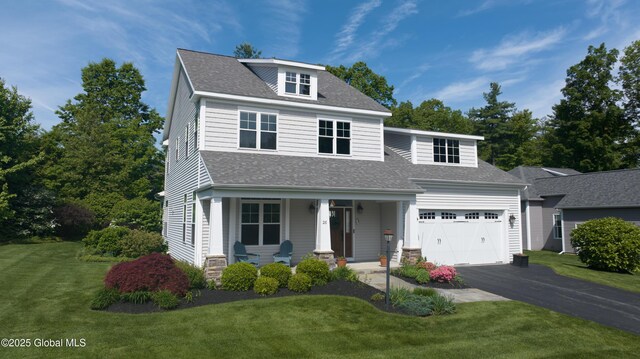 26 Galleon Dr Unit 26, Malta, NY 12020 - view of front facade with covered porch, asphalt driveway, a front yard, and a shingled roof