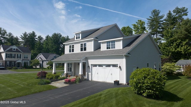 26 Galleon Dr Unit 26, Malta, NY 12020 - view of front facade with asphalt driveway, a front yard, roof with shingles, an attached garage, and covered porch