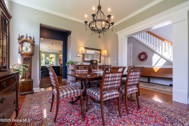 26 Galleon Dr Unit 26, Malta, NY 12020 - dining area with wood finished floors, a chandelier, ornamental molding, and baseboards