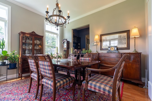 26 Galleon Dr Unit 26, Malta, NY 12020 - dining area featuring a chandelier, wood finished floors, crown molding, and baseboards